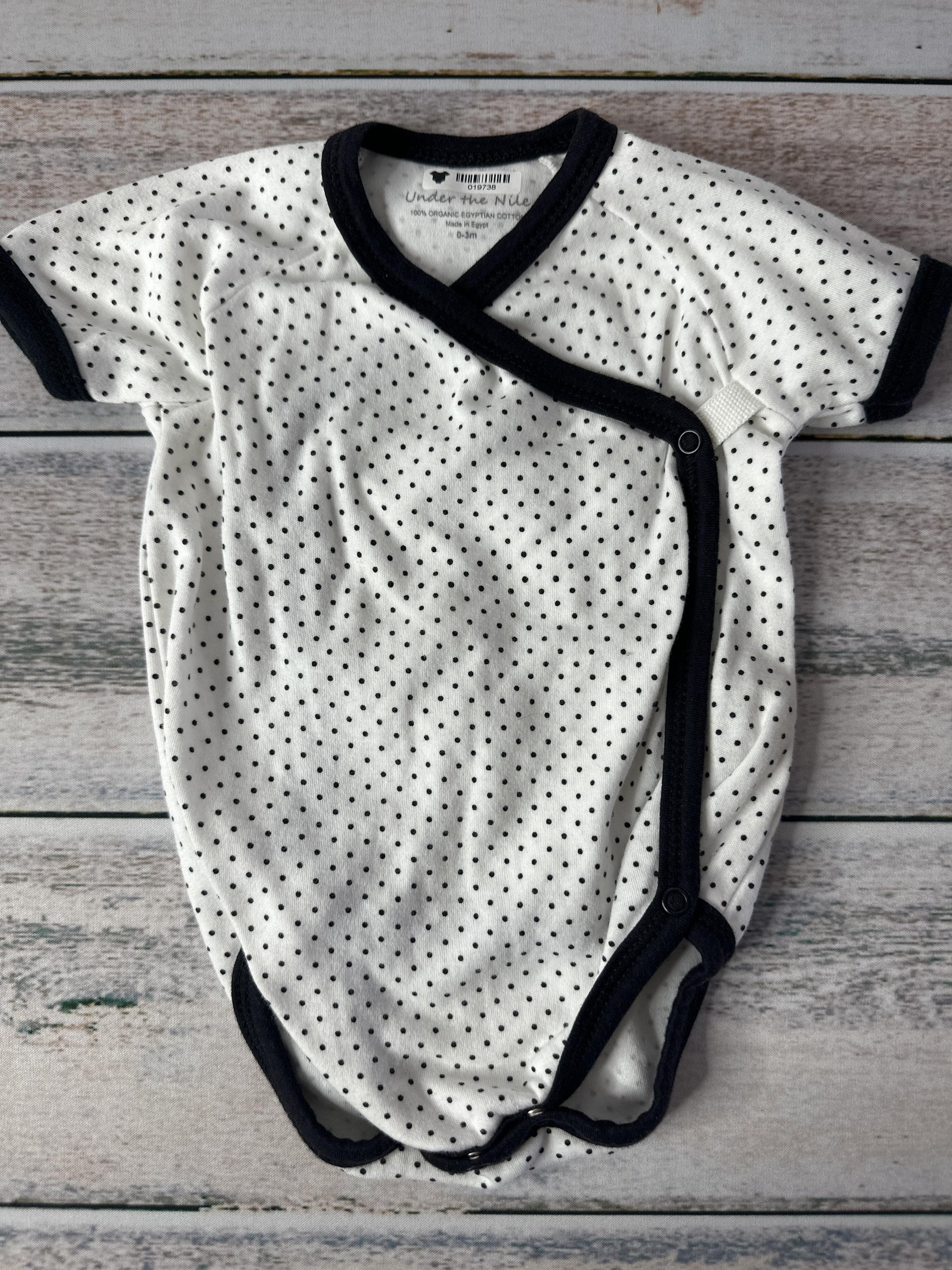 Under The Nile Unisex White | Black Onesie Size: 0-3 months White | Black